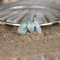 Follow the Waves - A handmade hammered recycled sterling silver 925 bangle decorated with three beautifully unique pieces of sea glass collected from the North Devon coast.
