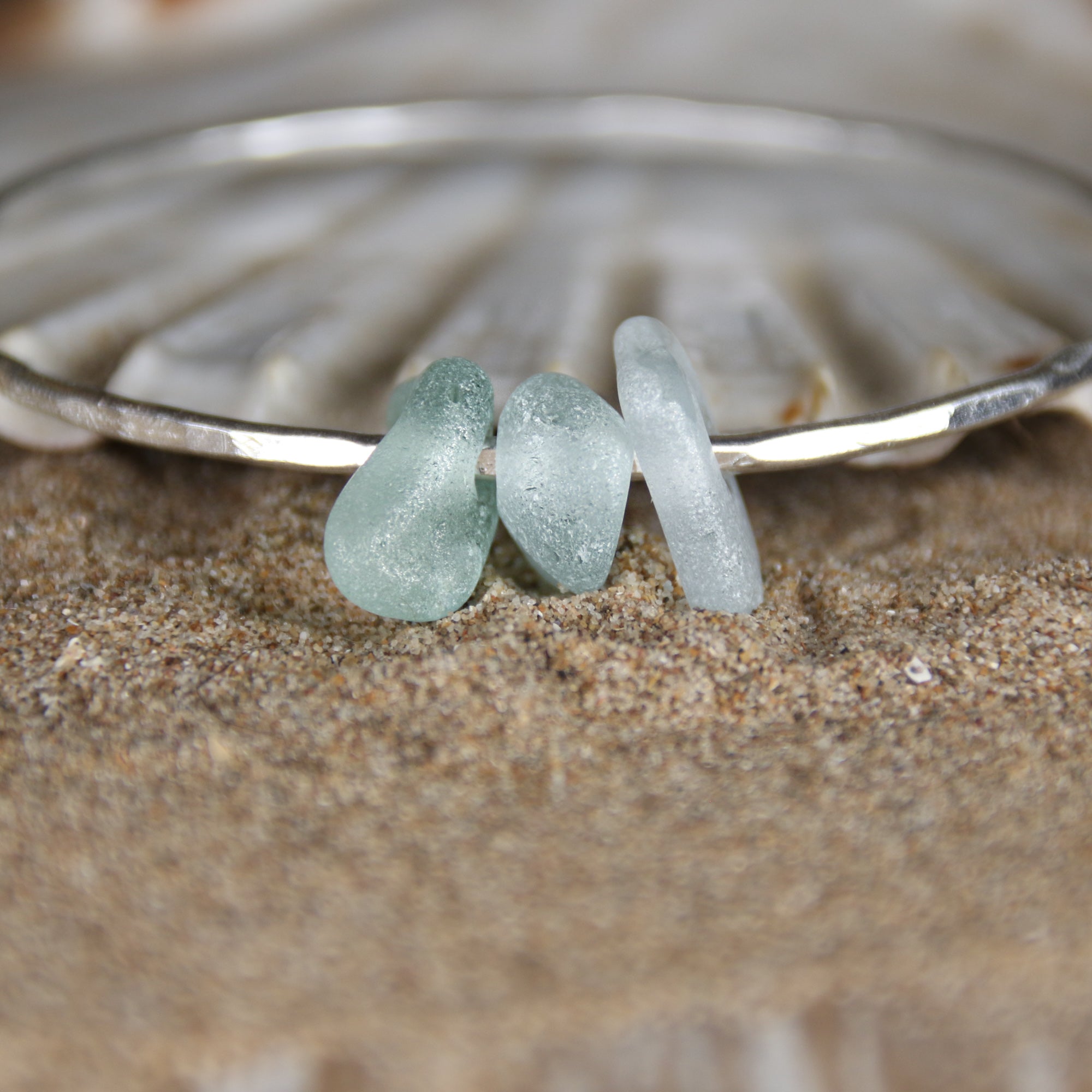 Follow the Waves - A handmade hammered recycled sterling silver 925 bangle decorated with three beautifully unique pieces of sea glass collected from the North Devon coast.