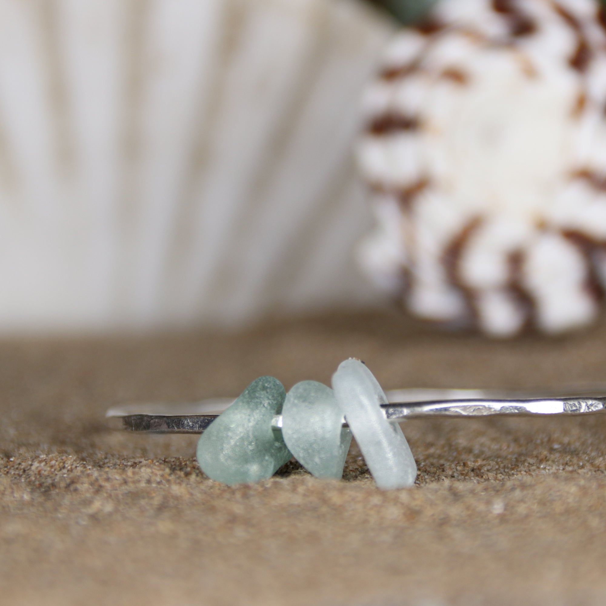 Follow the Waves - A handmade hammered recycled sterling silver 925 bangle decorated with three beautifully unique pieces of sea glass collected from the North Devon coast.
