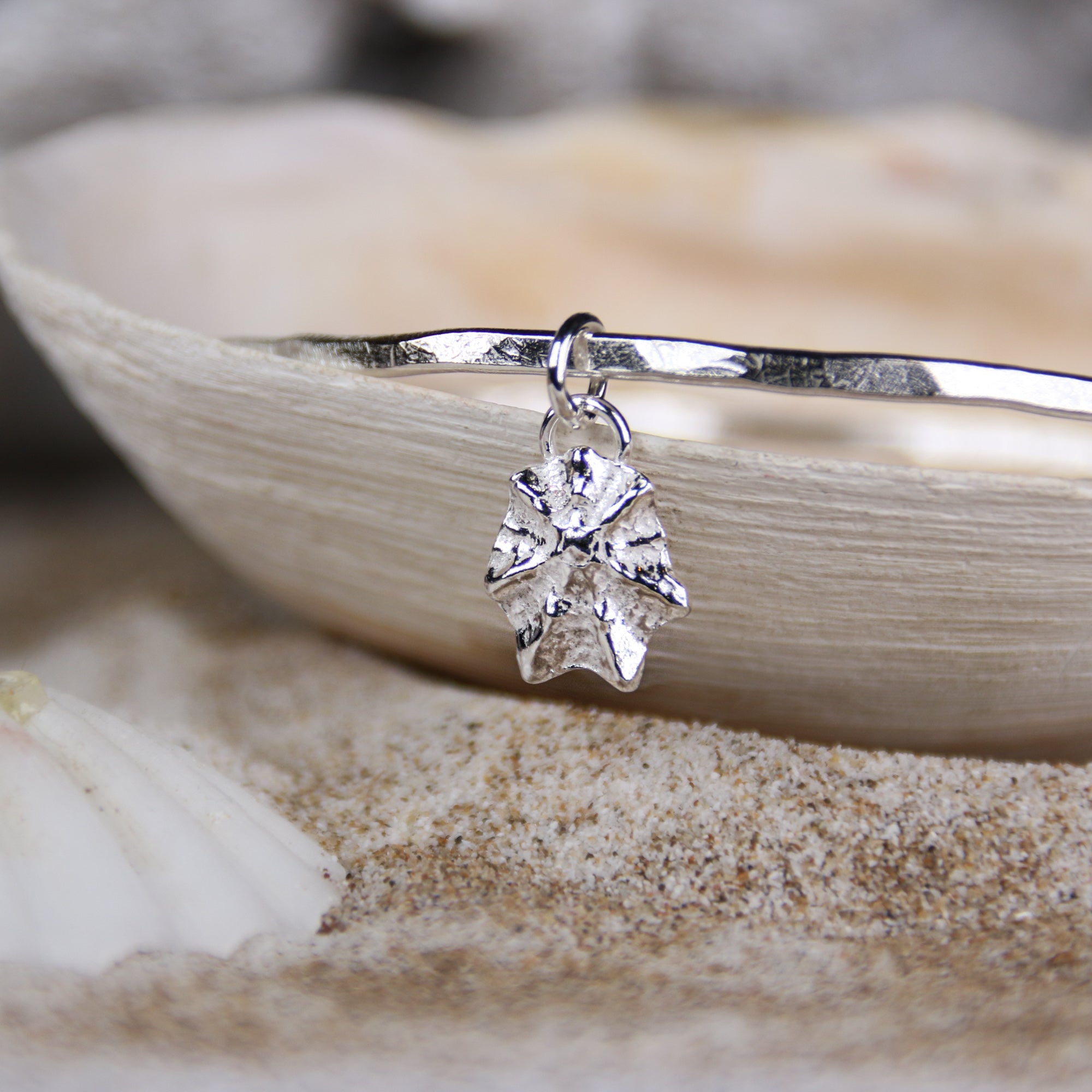 Silver Limpet Bangle - Saltwater Souls fine silver (.999) cast limpet shell charm on a hammered effect recycled sterling silver bangle.