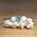 Undercurrent - Saltwater Souls sea glass and shiva shell recycled sterling silver open back bangle.