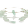 Follow the Tides - A handmade hammered recycled sterling silver 925 bangle decorated with a beautifully unique piece of seafoam coloured sea glass collected from the North Devon coast.