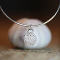 Little Urchin Bangle - Saltwater Souls fine silver (.999) cast urchin shell texture charm on a hammered recycled sterling silver bangle.
